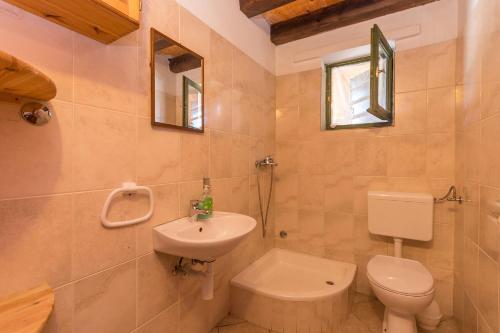 a bathroom with a toilet and a sink at House Jure in Tkon