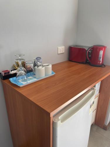 a kitchen with a wooden counter top with appliances on it at Town & Country Motor Inn in Forbes