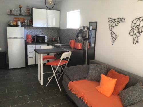 a kitchen with a couch and a table in a room at Sunset Villa in Siófok