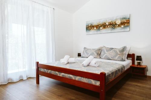 a bedroom with a bed with two towels on it at Hotel Medjugorje Irish Centre in Međugorje