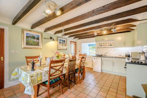 a kitchen and dining room with a table and chairs at Smithy House in Lochgilphead