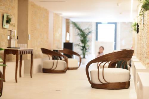 a row of chairs and tables in a room at Château de Fiac - Luxurious Hôtel & Spa in Fiac