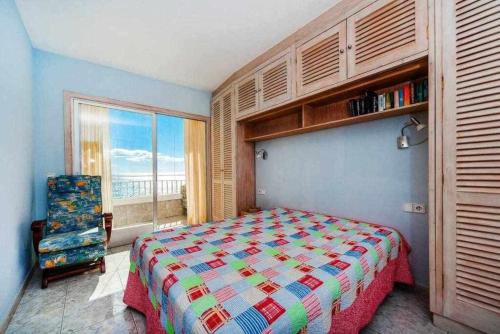 a bedroom with a bed and a view of the ocean at Espanhouse Maestro sea view apartment in Torrevieja