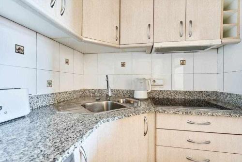 a kitchen with a sink and a counter top at Espanhouse Maestro sea view apartment in Torrevieja