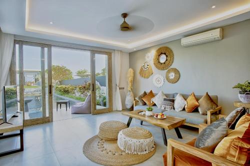 a living room with a couch and a table at Bali Diamond Estates & Villas in Keramas