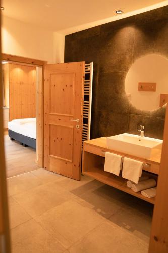 a bathroom with a sink and a mirror at Anewandterhof in Brunico