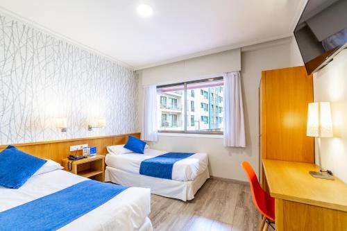 Кровать или кровати в номере Hotel Atlántico Vigo