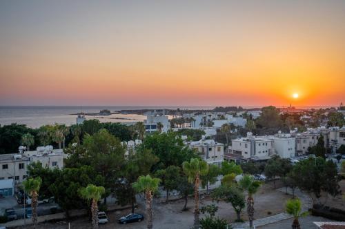a cityscape of a city at sunset at The Palmiers in Paphos City