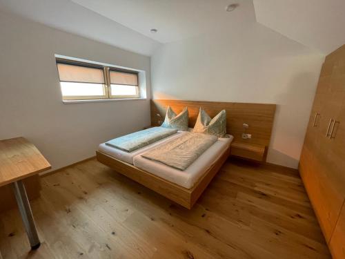 ein kleines Schlafzimmer mit einem Bett und einem Fenster in der Unterkunft Das Haus am Anger in Breitenbrunn