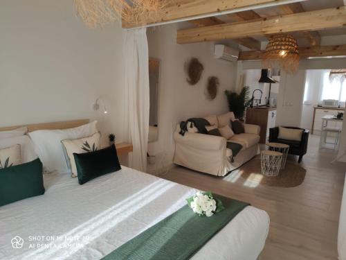 a bedroom with a large bed and a living room at Beach and Sun , Centro Fuengirola, 2 minutos playa CON PARKING OPCIONAL in Fuengirola