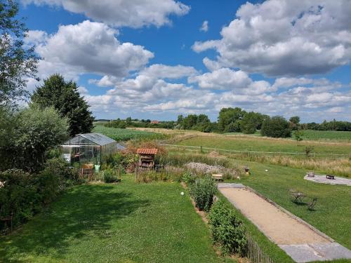 a garden with a greenhouse in the middle of a field at B&B Clogher Farm in Poperinge