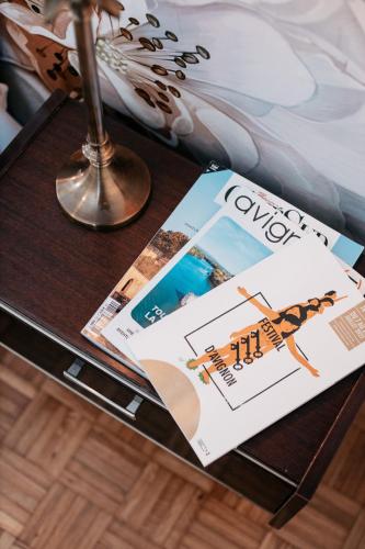 a table with a magazine on top of a table at Les Précieuses Suites & Spa II in Avignon