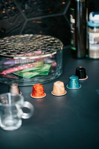 a group of different colored caps sitting on a table at Les Précieuses Suites & Spa II in Avignon
