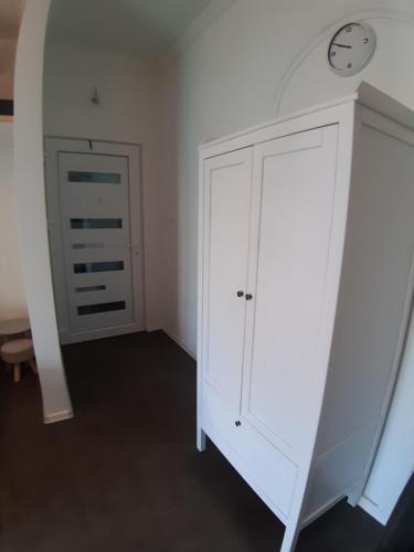 a white cabinet with a clock on top of it at MY WAY BB in Bag