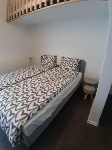 a bed with black and white sheets and pillows at MY WAY BB in Bag