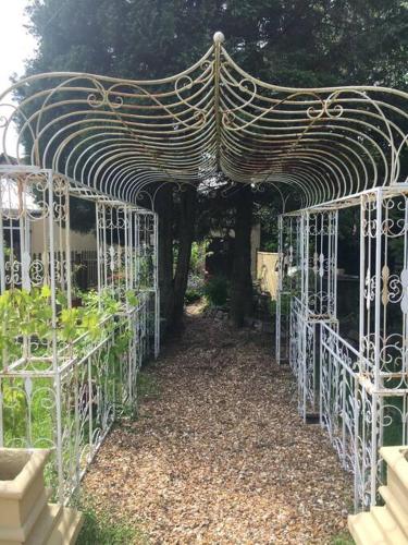 a gazebo in a garden with plants in it at The Jewel in the Crown, countryside escape in Rushton Spencer