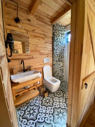 a bathroom with a white toilet and a sink at Şana Yaşam Köyü 