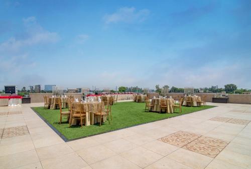 a banquet hall with tables and chairs on the grass at Hotel Home In By Amrik Sukhdev in Sonīpat