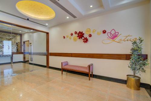 a waiting room with a bench and a sign on the wall at Hotel Home In By Amrik Sukhdev in Sonīpat