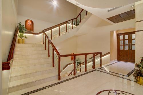 a staircase in a house with wooden railings at Hotel Home In By Amrik Sukhdev in Sonīpat
