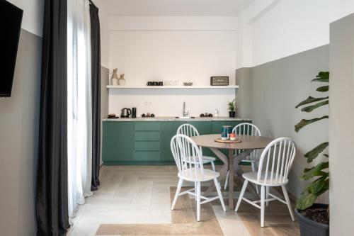 a kitchen and dining room with a table and chairs at Play Theatrou Athens in Athens