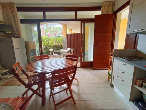 Una cocina con una mesa y sillas de madera en una habitación. en App Casa Dei Pini - Bilocale, en Capoliveri