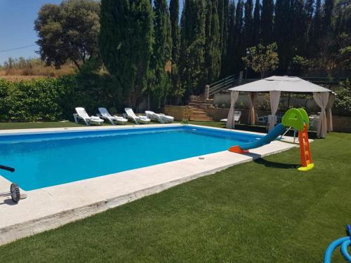 - une piscine avec toboggan et parasol dans l'établissement La Casa del Sauce, à Archidona
