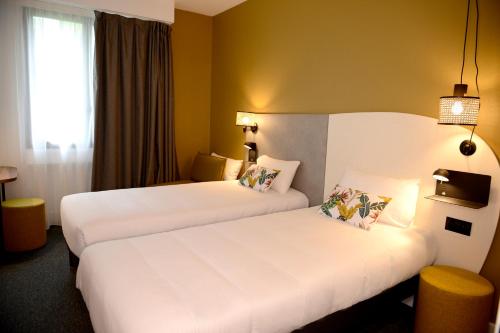 Hôtel Villa Berliozにあるベッド