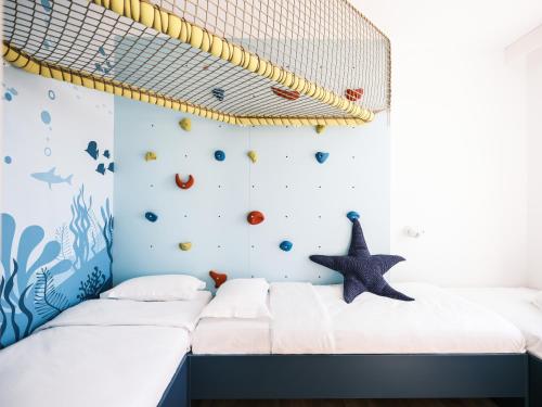a childrens room with a net on the wall at Falkensteiner Family Hotel Diadora in Zadar