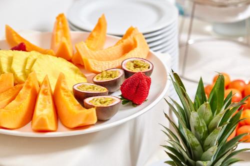 a plate of food with fruit on a table at Hotel Ascot Riccione in Riccione