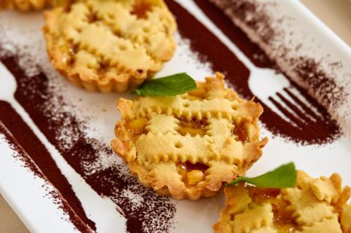a plate with a fork and some food on it at Hotel Ascot Riccione in Riccione