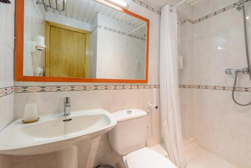 a bathroom with a sink and a toilet and a mirror at Hotel Vibra Mare Nostrum in Playa d'en Bossa