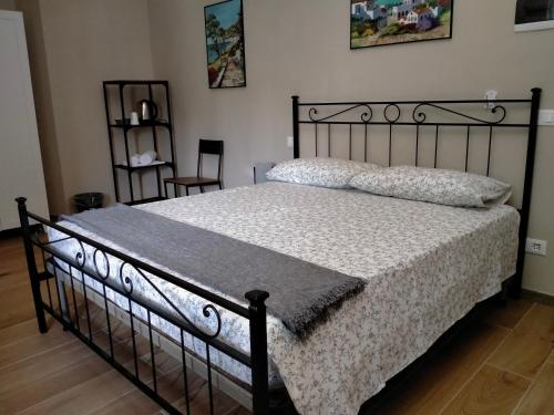 a bedroom with a bed with a black bed frame at il Cantuccio in Lucca