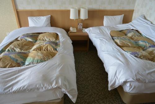 En eller flere senge i et værelse på Toya Kanko Hotel