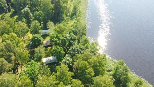 an aerial view of a house on a hill next to the water at Duriu sodyba in Molėtai