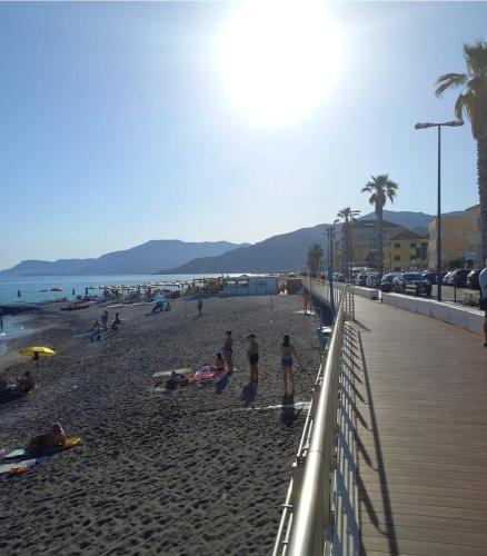 a group of people on a beach near the ocean at Affittacamere L'Orchidea in Ventimiglia