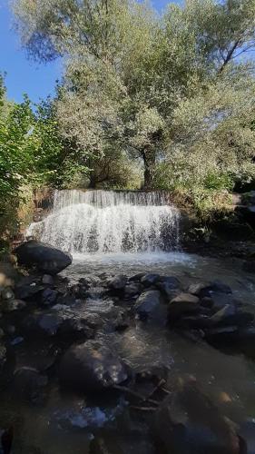a waterfall in the middle of a river at Guest house VL in Alaverdi