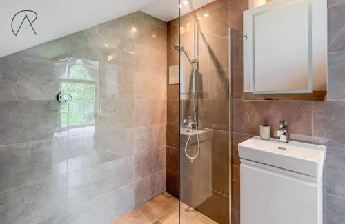 a bathroom with a shower with a toilet and a sink at Dorney Barn, Close To Windsor Legoland in Dorney