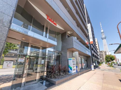 a building with the eiffel tower in the background at Tabist Urban Stays Asakusa in Tokyo