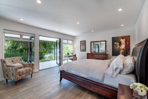 1 dormitorio con 1 cama grande y 1 silla en Multiview Manor, en Los Ángeles