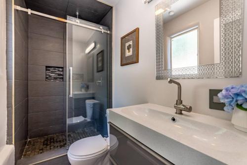 a bathroom with a shower and a toilet and a sink at Multiview Manor in Los Angeles