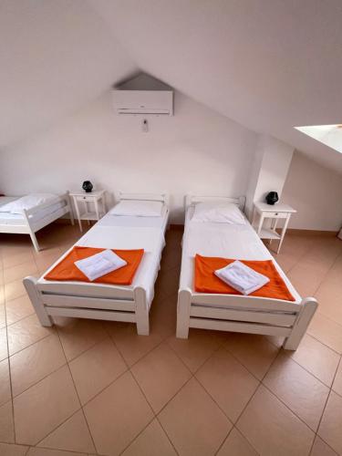 a room with two beds and a basketball hoop at Apartments Andrea in Stara Novalja