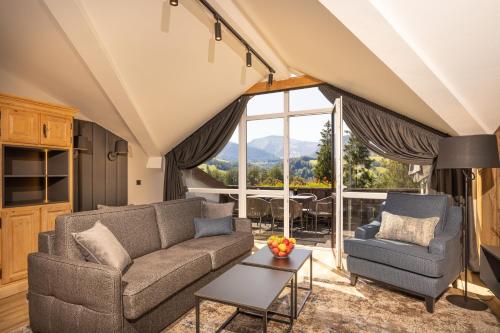 a living room with a couch and a table at MONDI Resort und Chalet Oberstaufen in Oberstaufen