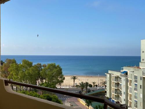a view of a beach and the ocean from a balcony at Apartamento Nuevo MannA in Oropesa del Mar