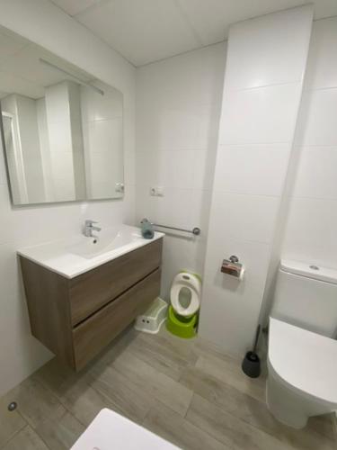 a white bathroom with a sink and a toilet at Apartamento Nuevo MannA in Oropesa del Mar