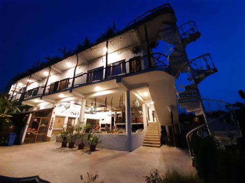 a large building with a balcony at night at Matsya in Havelock Island
