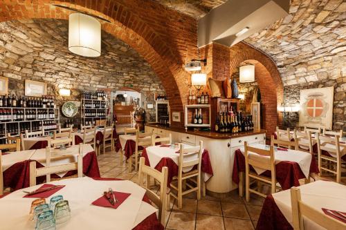 a restaurant with tables and chairs and a stone wall at Casa Vacanze Alessandro 2 in Greve in Chianti