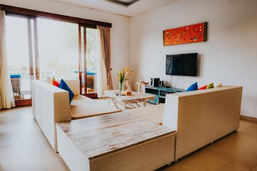 a living room with a couch and a table at Bali Diamond Estates & Villas in Keramas