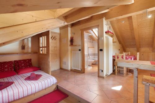 a bedroom with a bed and a table in a room at La Baitina app C in Livigno