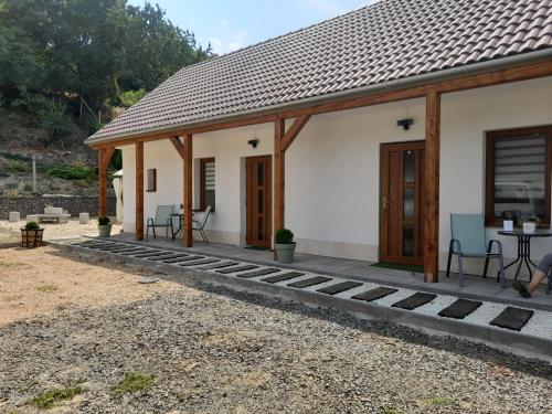 mały biały domek ze stołem i krzesłami w obiekcie Kaland apartman II. w mieście Sátoraljaújhely